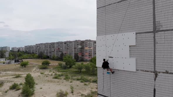 Industrial Alpinism. Aerial View. Work on Outer Insulate Building with Styrofoam