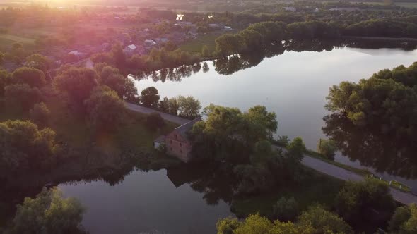 Flight over the dam where the mill was built, the road through the dam, the settlement near the pond