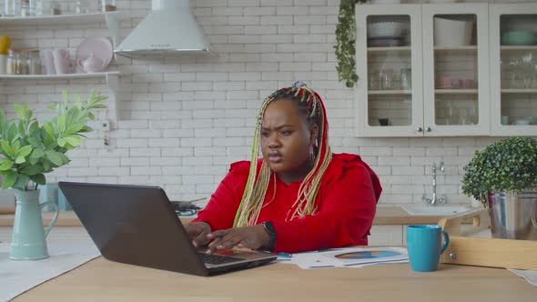 African Female Entrepreneur Working in Home Office