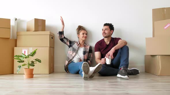 Young couple catching a break while moving house 