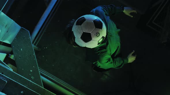 Football Freestyle. Young Man Practices with Soccer Ball in Parking and Roof