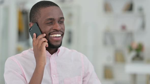 Portrait of Cheerful African Man Talking on Smartphone
