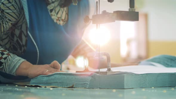 Female Employee Is Cutting Cloth with a Razor Mechanism