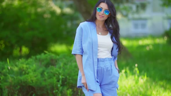 Woman in Blue Costumes and Sunglasses