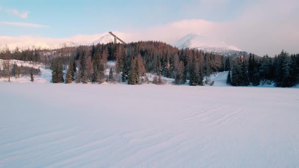 Establisher aerial drone view of High Tatra ski jumping tower, forward, day