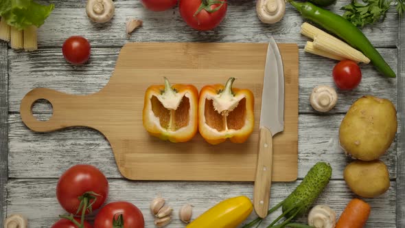 Two Male Hands Taking Halves of Orange Paprika From the Board Simultaniosly.