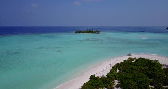 Natural birds eye island view of a white sandy paradise beach and aqua blue ocean background 