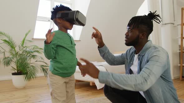Father and son at home using VR