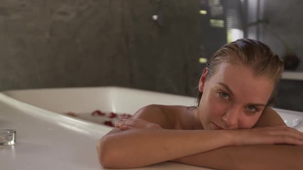 Caucasian woman taking bath in hotel