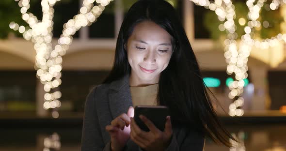 Business Woman Use of Mobile Phone at Night