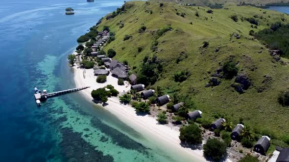 Komodo resort in Pulau Sebayur island Indonesia with clear reef beach, Aerial pedestal rising shot
