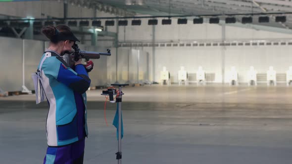 Girl in a  Suit  Aiming at  Target