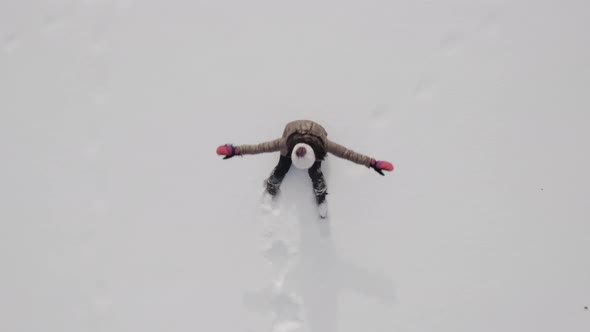 Woman making a snow angel