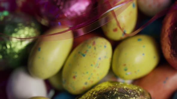 Rotating shot of colorful Easter candies on a bed of easter grass - EASTER 