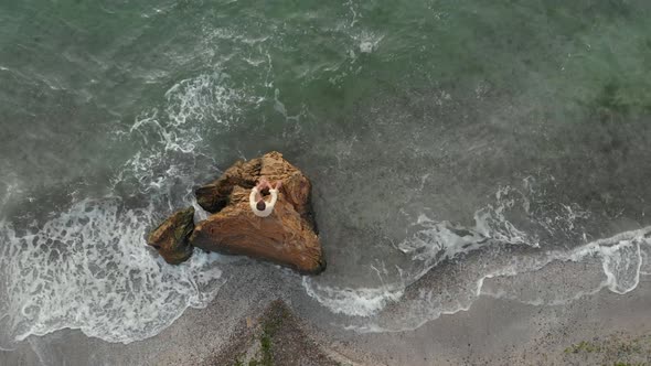 A Young Man Rests By the Sea