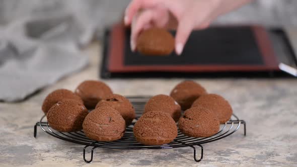 Freshly Baked Chocolate Profiteroles on Cooling Rack.