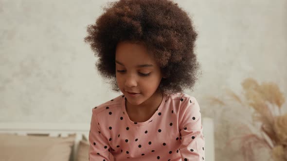 Cute Little African American Girl Focused on Something