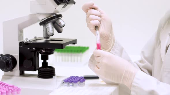 Medical Test in Laboratory, Scientist Using a Micro Pipette in a Laboratory