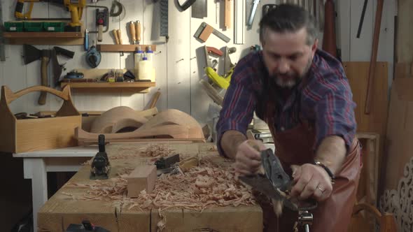 Joiner Planes Solid Wood in his Workshop