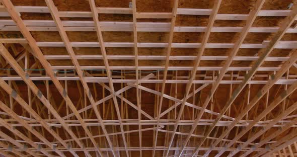 An Interior Viewed of Wooden Beams at Construction the Roof Truss System