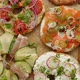 Tasty Colorful Various Bagels with Healthy Ingredients Served on Brown Baking Paper - VideoHive Item for Sale