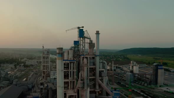 Cement Plant with High Factory Structure at Industrial Production Area at Sunset