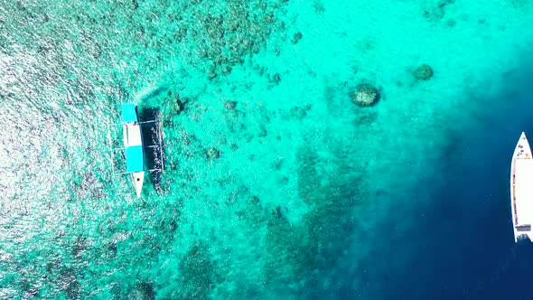 Daytime birds eye travel shot of a paradise sunny white sand beach and blue ocean background