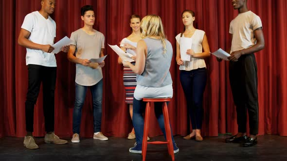 Actors discussing their scripts on stage 4k