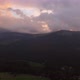 Aerial view of dark moody sunset in the mountains. Green woods and pink skies - VideoHive Item for Sale