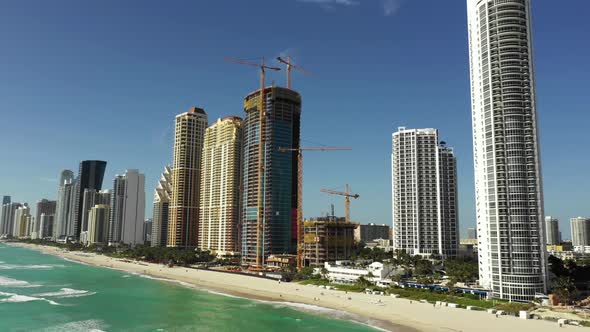 Modern highrise towers on the beach aerial 4k video