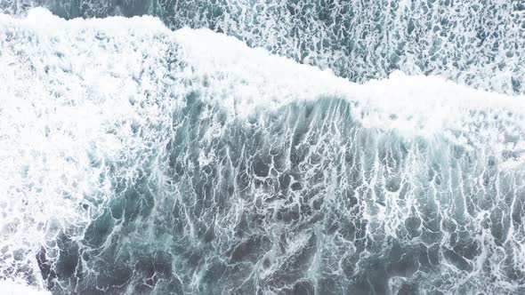 Aerial View of Beautiful Beach with View of Ocean Waves and Water Crashing on to Sandy Shore From