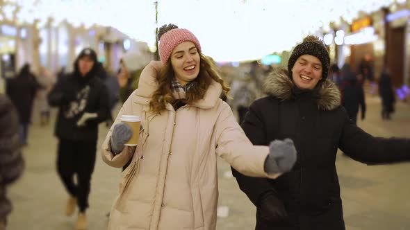 Young couple having fun on street in winter