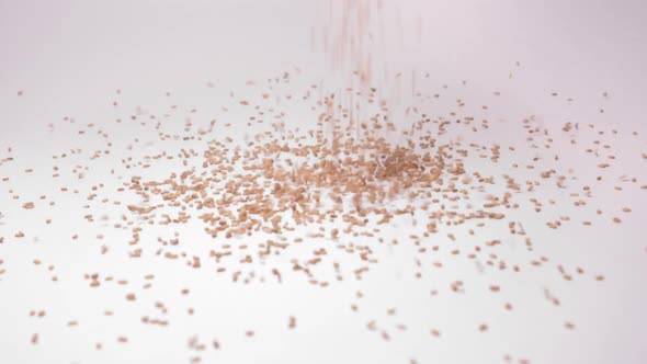 Heap Of Sesame Seeds Dropping In White Background. close up