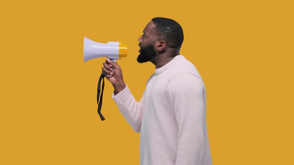 Handsome Black Man Shouting By Megaphone on Yellow Background