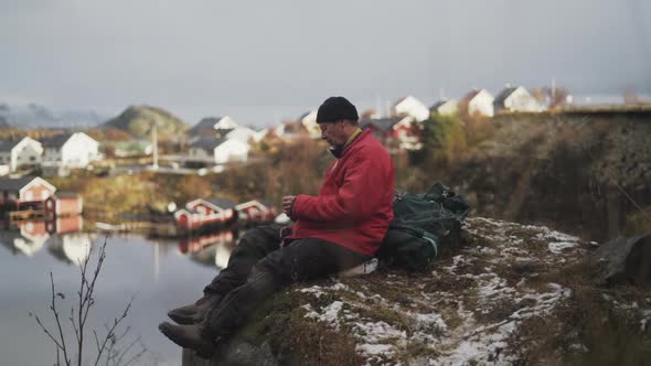 Resting Hiker On Rock By Reine Village