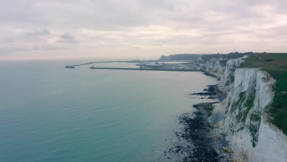 Aerial drone shot along white cliffs of dover towards dover harbour