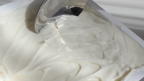 Slow motion cream cheese taking with metallic spoon video