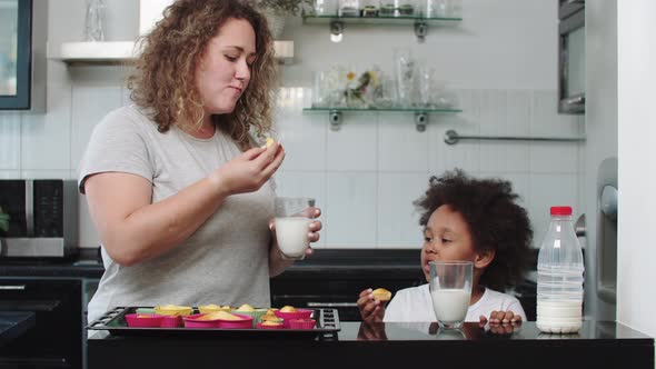 White Mother with Her Black Mixed Daughter Eating Cupcakes with Milk