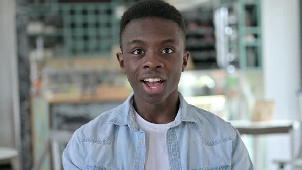 Portrait of Excited Young African Man Celebrating Success