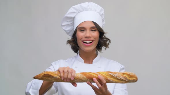 Happy Female Chef with French Bread or Baguette