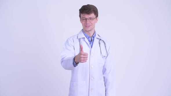 Happy Young Handsome Man Doctor Giving Thumbs Up