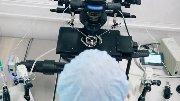 A Woman Uses Medical Microscope While Working in Laboratory.