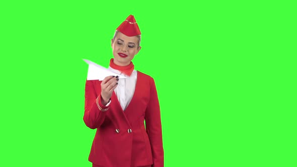 Girl Is Launching a Paper Airplane. Green Screen