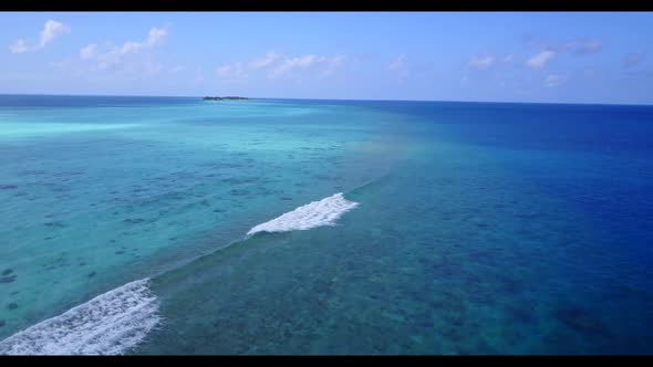 Aerial top view nature of marine coast beach holiday by shallow ocean with white sandy background of