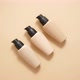 Bottles of Three Different Shades of Makeup Foundation on Beige - VideoHive Item for Sale