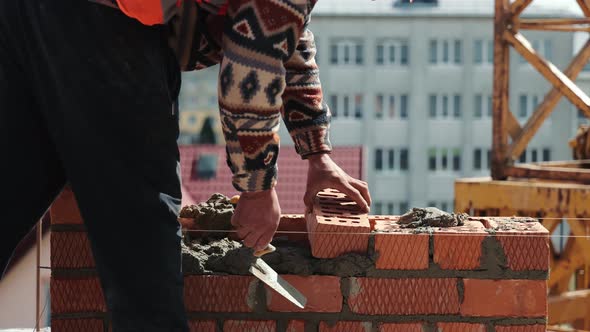 Close Up of a Man Building a Brick House