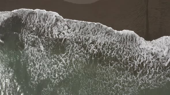 Drone view of waves on the beach
