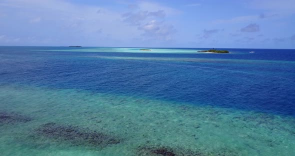 Tropical flying clean view of a summer white paradise sand beach and blue ocean background in high res