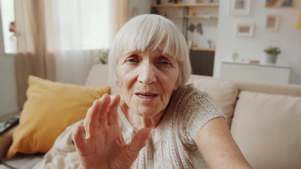 Senior Woman Speaking on Video Call at Home