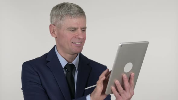 Senior Businessman Browsing Internet on Tablet, White Background